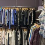 Cold Bath Road charity shop rail with blue clothes