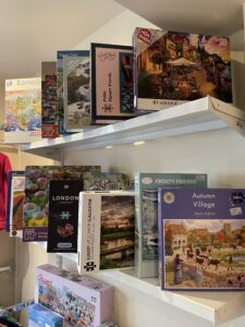 Puzzles on a shelf in Boroughbridge Charity Shop