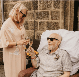 Lesley and Steve wearing sunglasses and toasting champagne on their wedding day at Saint Michael's.