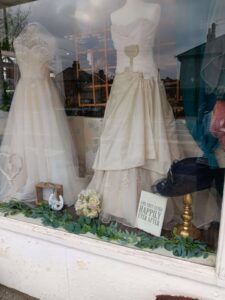 Two beautiful preloved wedding dresses in the window of our Bilton shop